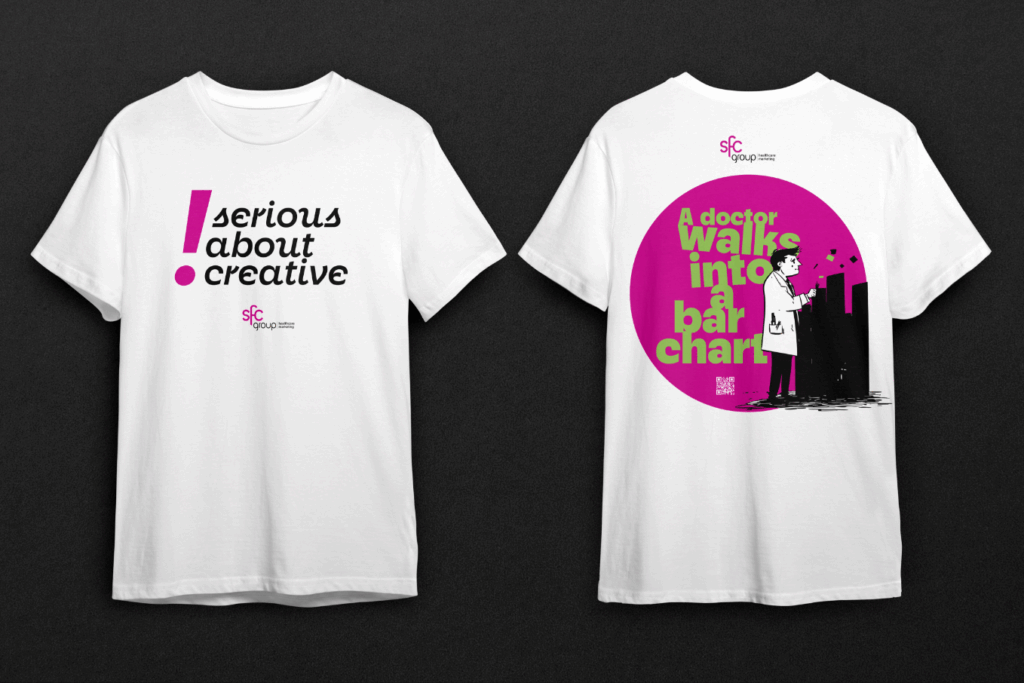 Two white t-shirts displayed front and back against a dark background. The front of the left t-shirt features the word "Seriously?" in large bold black text centered on the chest. The back of the right t-shirt has a large black circular design with pink and white text reading "We launched a new campaign and all I got was this lousy T-shirt!" alongside a cartoon illustration of a sad-faced girl with pigtails tied in pink bows, large eyes, and a downturned mouth. A small QR code is placed near the bottom right of the circle, and the "sfc group healthcare marketing" logo in pink is at the base of the design.